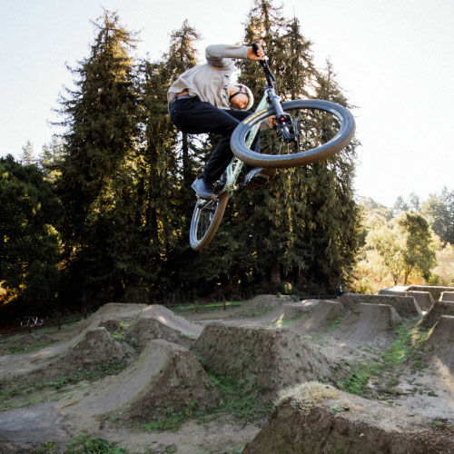 Eddie Reynolds jumping his bike in a bike park.